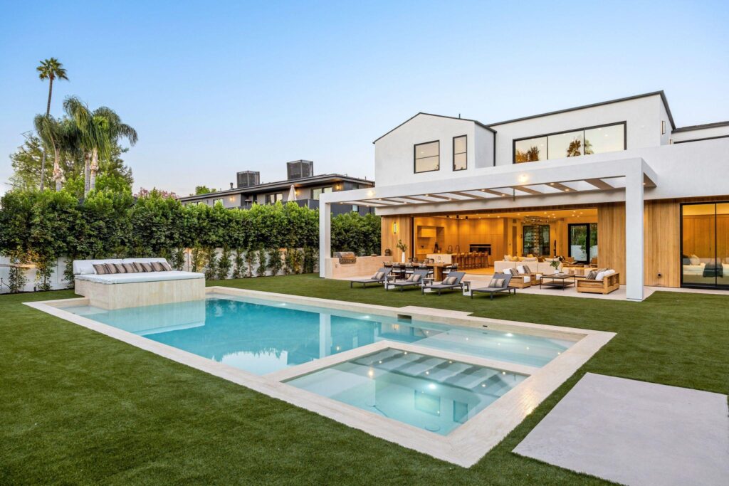 Luxury backyard pool with premium landscaping and outdoor living features.