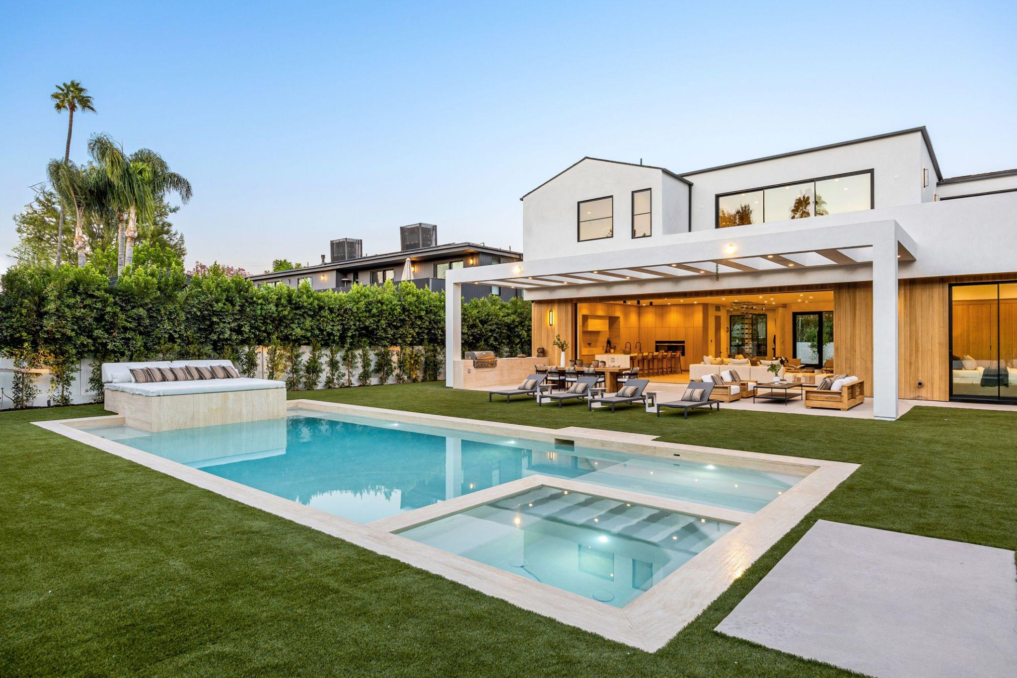 Luxury backyard pool with premium landscaping and outdoor living features.