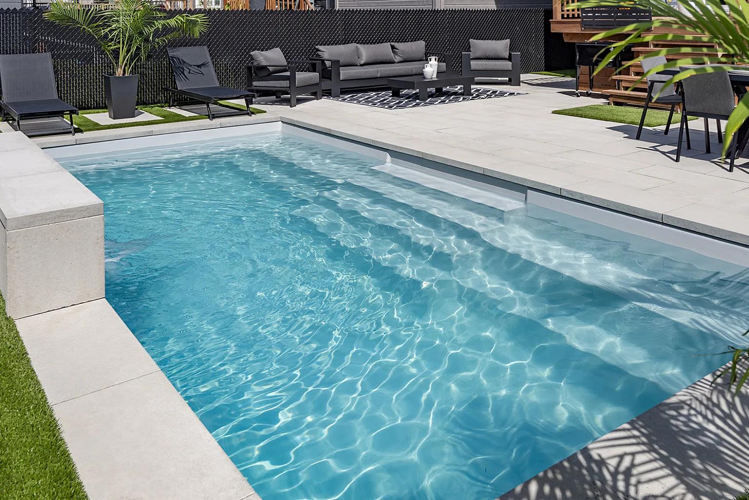 Mosaic fiberglass pool featuring a premium reflective finish and crystal-clear water.