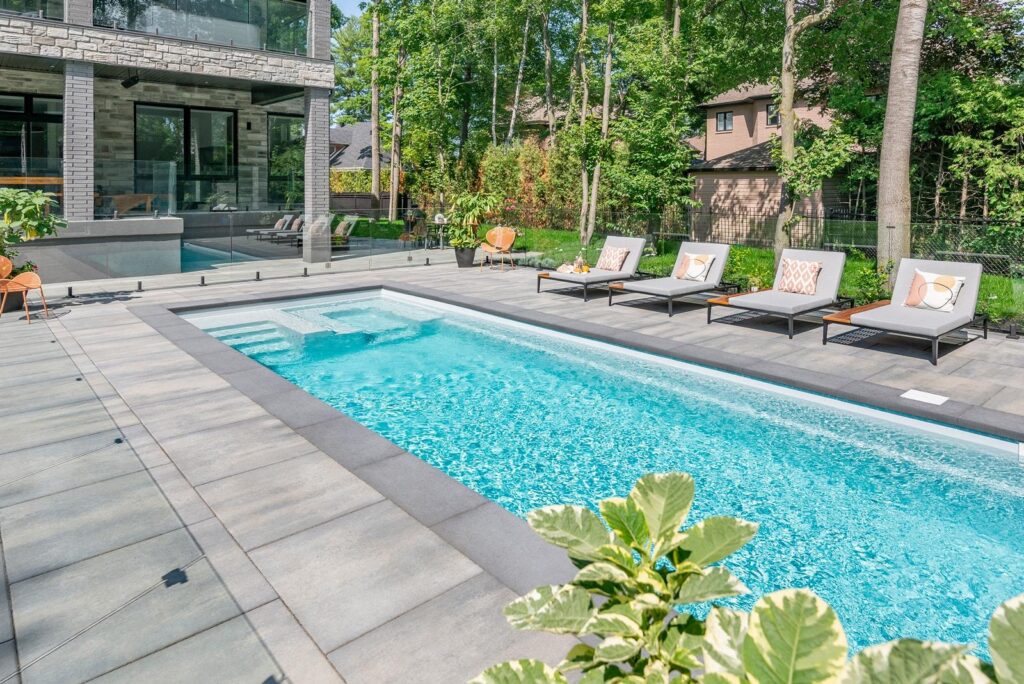 Modern fiberglass swimming pool professionally installed in a residential backyard