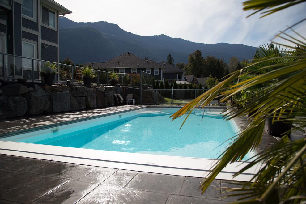 Fibreglass backyard pool with finished landscaping in British Columbia
